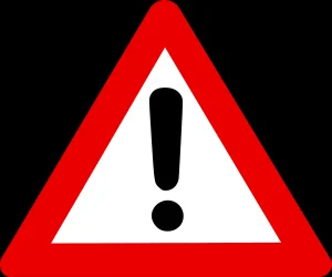 Triangular warning sign with a red border and a black exclamation mark, telling people to be careful