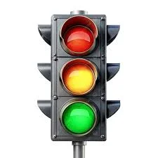 Traffic light with red, yellow and green lamps, showing the colours drivers and pedestrians must obey