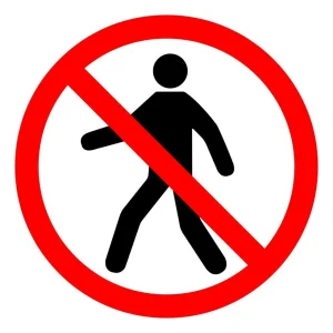 Red circle with a diagonal bar across a black walking figure, a sign telling people not to pass or enter